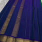 Emerald Green and Neelam Violet-Blue lightweight Kanchipuram silk saree, geometric gold zari border and patterned violet-blue pallu; pallu folds