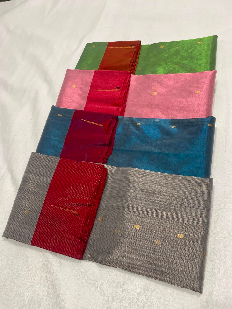 Close-up of gold and silver-toned metallic buttas on the Teal Blue Tissue Silk Chanderi saree.