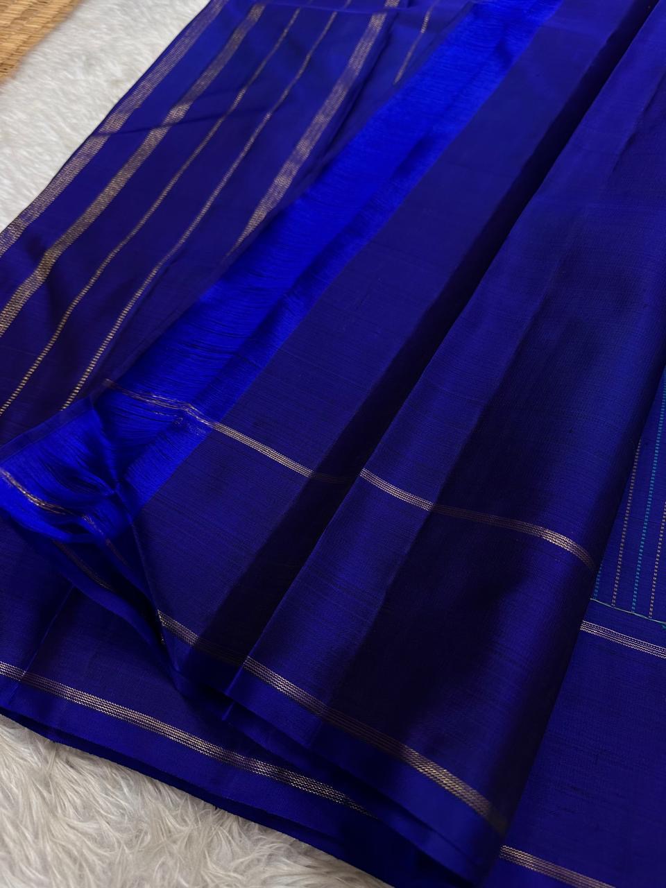 Elegant royal blue pure silk Kanjivaram saree with subtle striped weaving and classic border composition