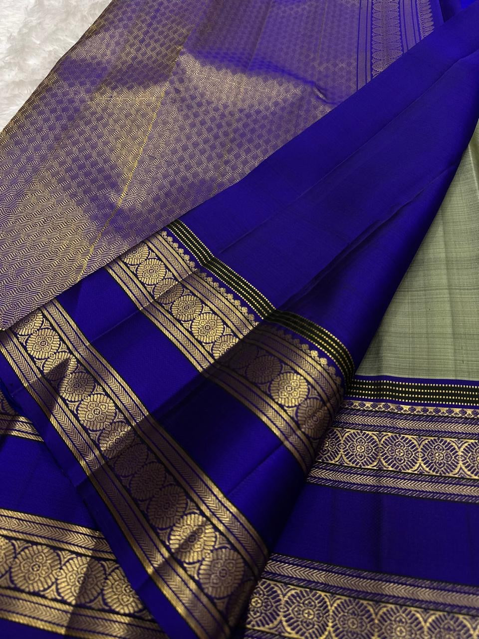 Traditional Gandaberunda motif detail on the sage green Kanchipuram silk saree.