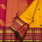 Traditional Butta weave detail on the golden turmeric Kanchipuram saree, silk thread motifs.
