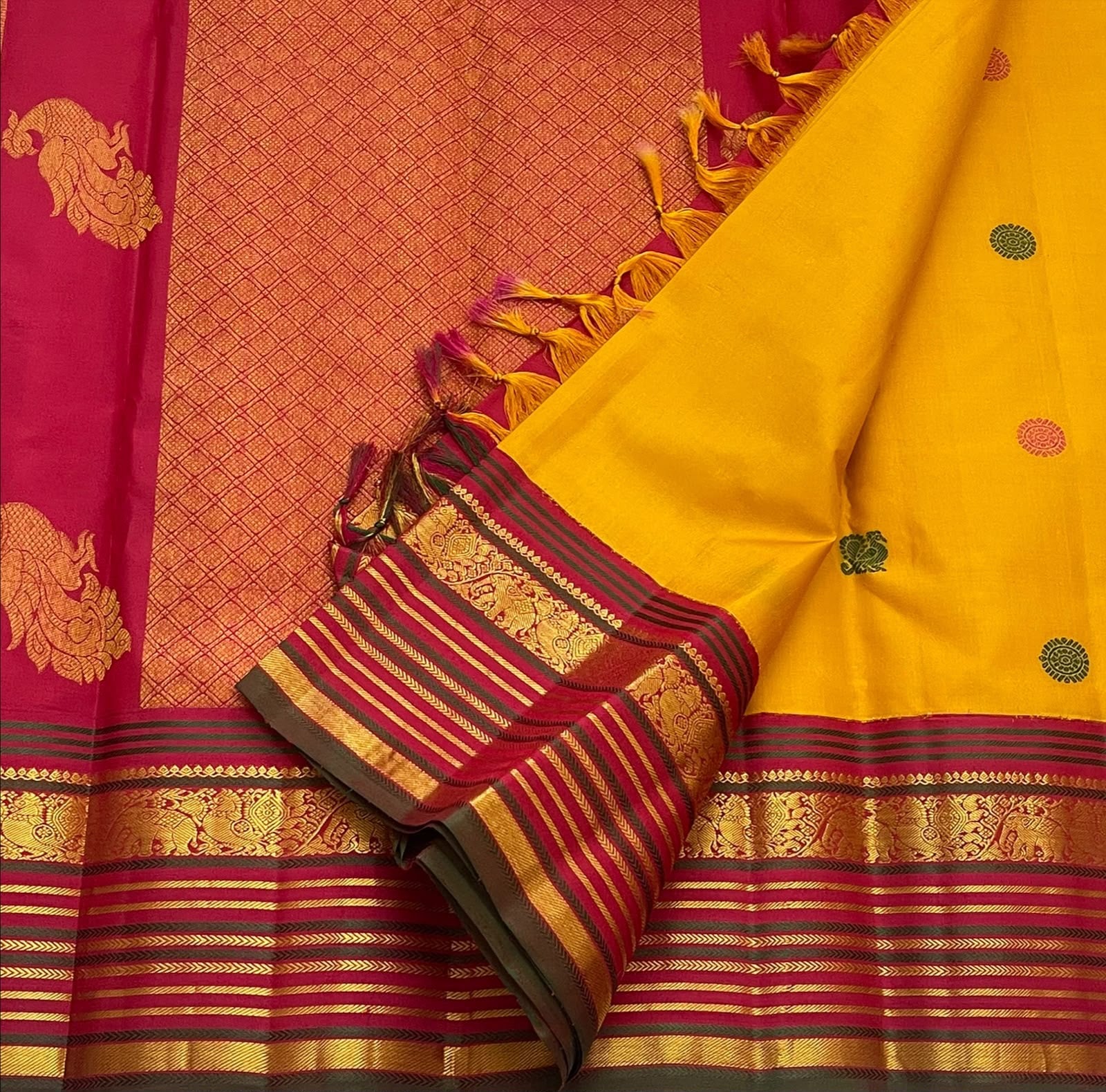 Traditional Butta weave detail on the golden turmeric Kanchipuram saree, silk thread motifs.