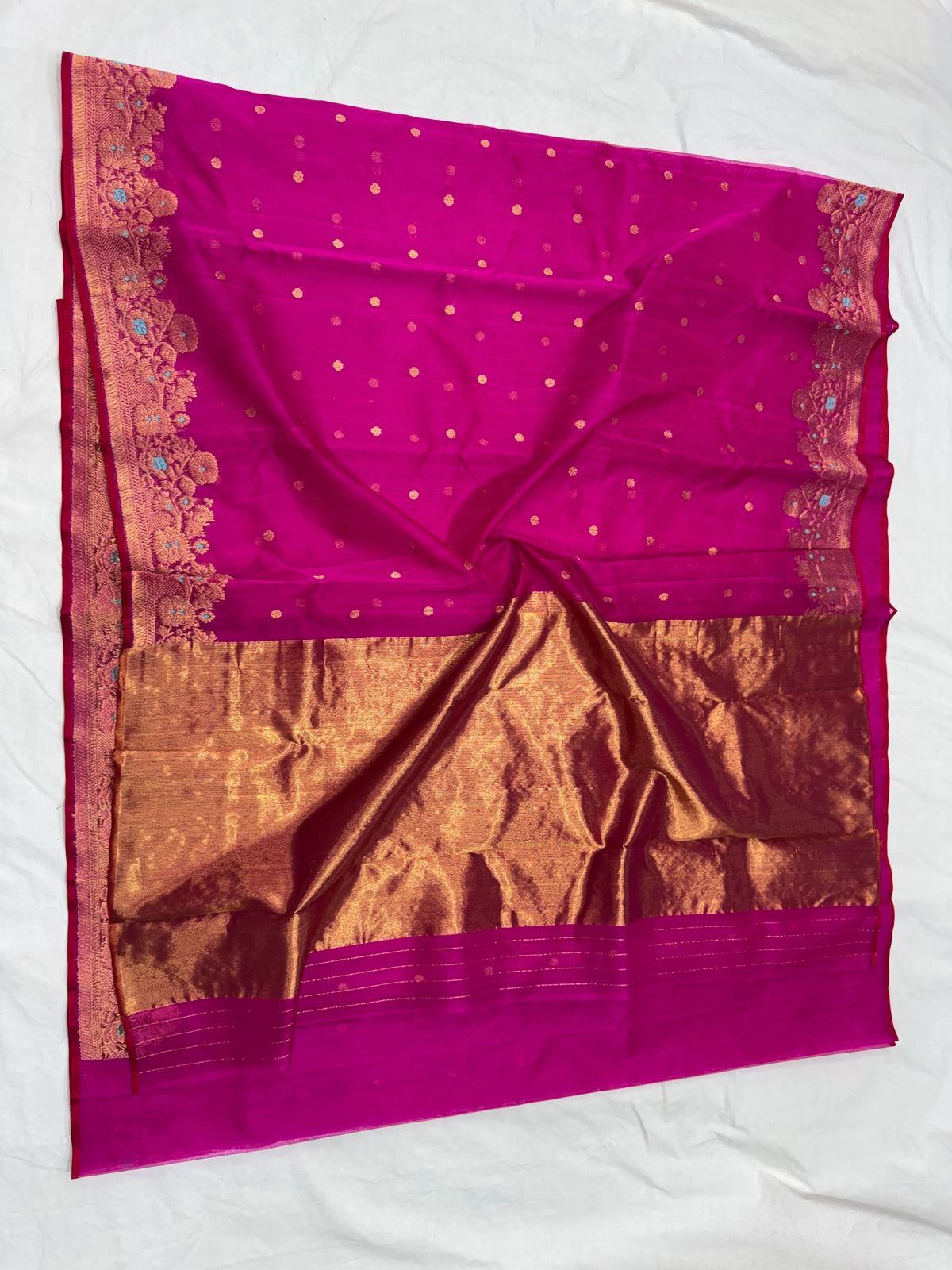 Purplish pink Chanderi Katan silk saree draped to show scattered gold-toned buttas above the wide gold-toned pallu