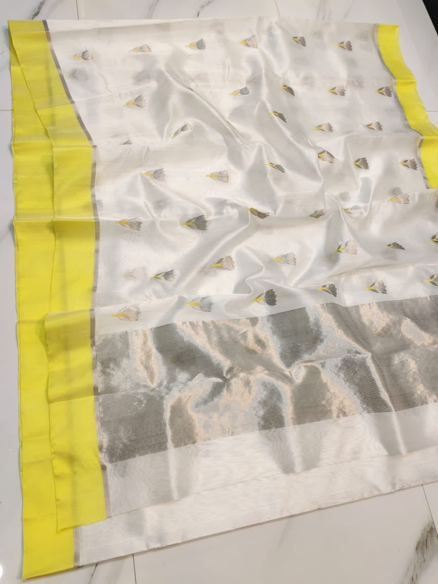 Close view of the ivory Chanderi body with grey floral-bud buttas and the lemon-yellow edge