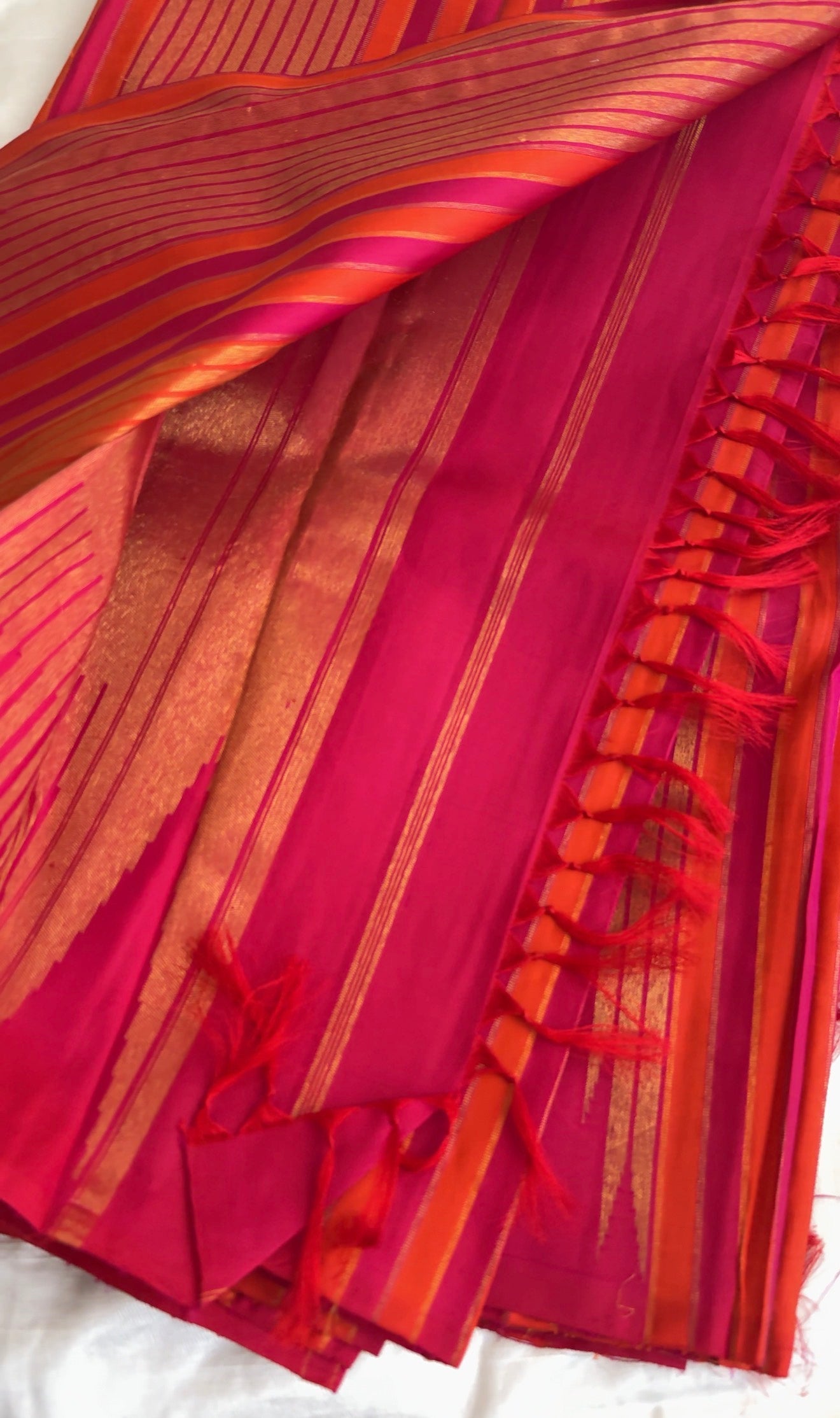 Traditional Ettukol Kanjivaram saree with warm pink and orange colour combination.