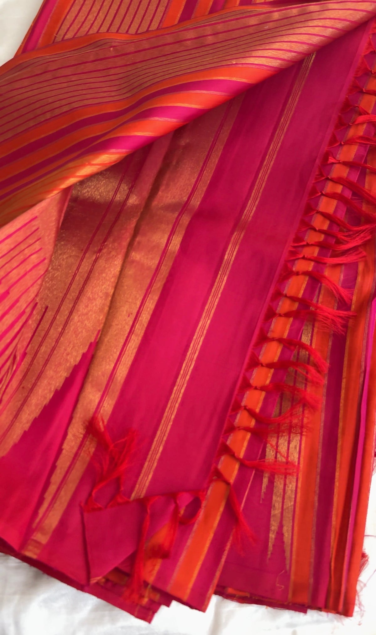 Traditional Ettukol Kanjivaram saree with warm pink and orange colour combination.