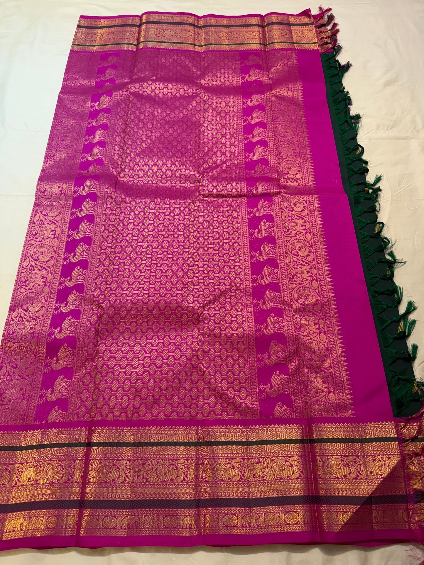 Gold zari mayil and kamalam butta detail on emerald green Kanchipuram silk saree body — Idam Living