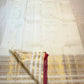 Delicate zari-woven buttas on ivory pure silk Kanchipuram saree body