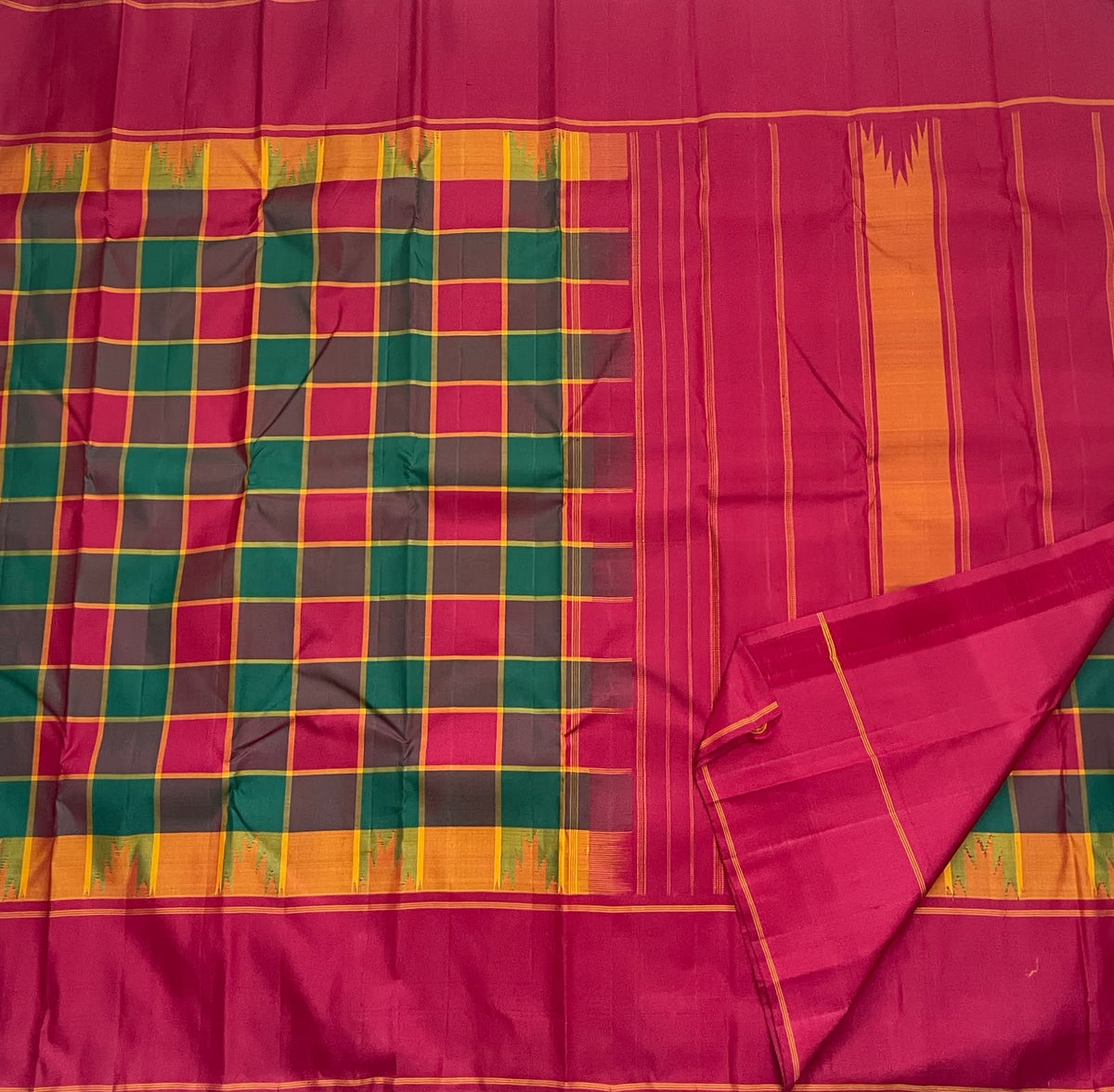 Maragatham green Kanchipuram silk saree, deep green seer pallu with narrow gold-toned lines and zari-edged band