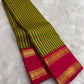 Traditional Kanchipattu saree with brick red rettapet border and gold zari detail flatlay Idam Living