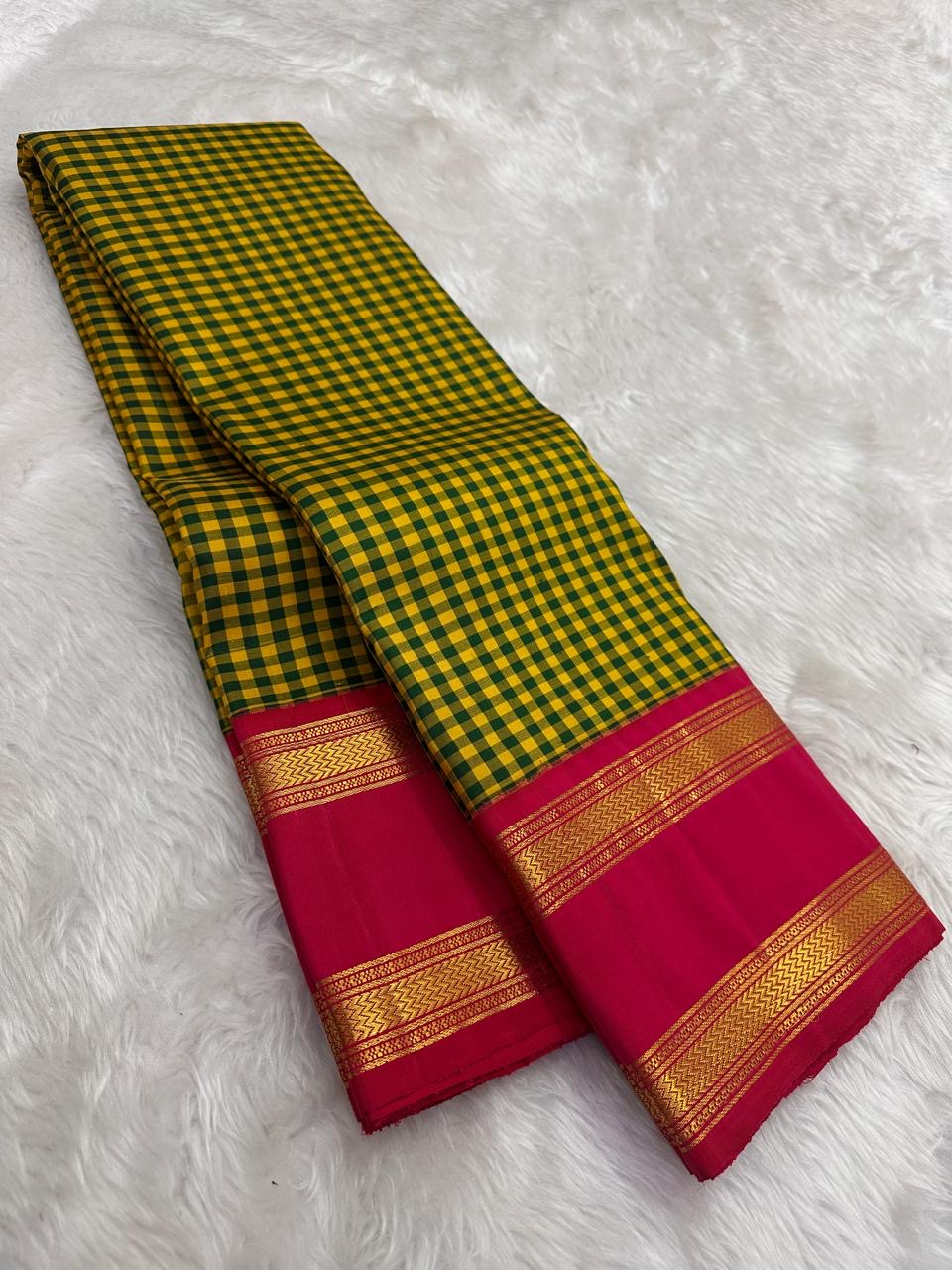 Traditional Kanchipattu saree with brick red rettapet border and gold zari detail flatlay Idam Living