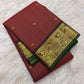 Vermilion red Kanchipuram silk saree folded, showing checked body, plum peacock border and pallu