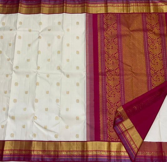 Close view of ivory Kanchipuram silk saree with yaanai elephant and mayil peacock butta motifs woven in classic gold zari