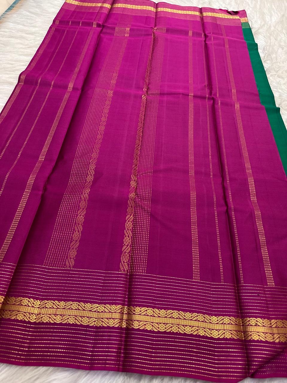 Emerald Green and Vadamalli Magenta lightweight Kanchipuram silk saree, spaced buttas and scrolling floral zari border; border detail