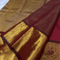 Close view of petite Gandaberunda zari buttas on the red silk body.