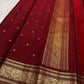 Folded dusty rose Kili Butta Pure Silk Kanjipuram saree with maroon border