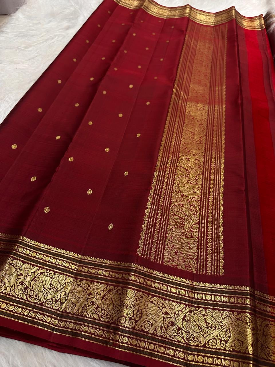 Folded dusty rose Kili Butta Pure Silk Kanjipuram saree with maroon border