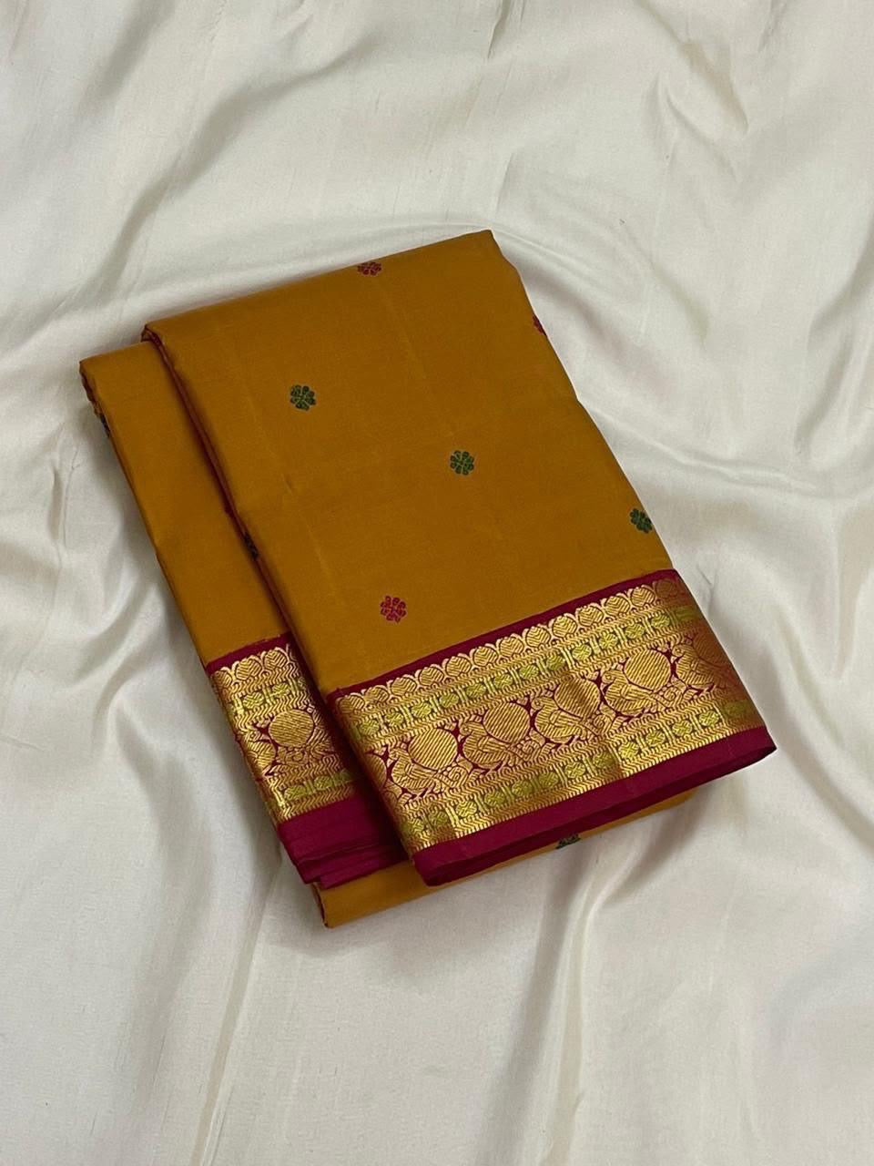 Multicoloured silk thread butta detail on golden ochre KanchiPattu silk saree