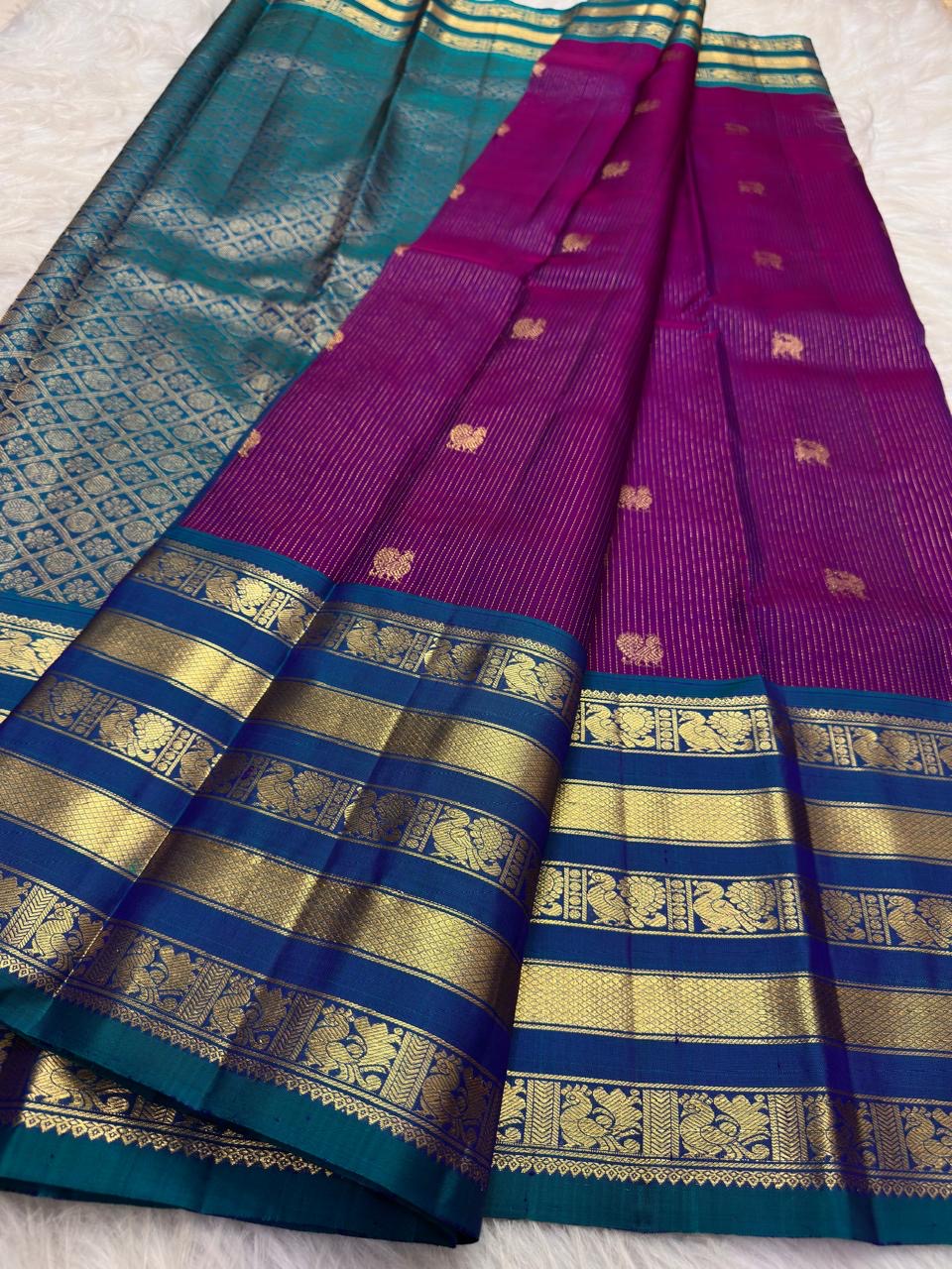 Vadamalli magenta silk body with fine gold oosivaanam stripes and spaced gold circular buttas