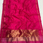 Delicate ornamental gold-toned border on rani-pink saree