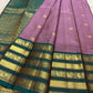 Grand teal green diamond-lattice gold zari pallu on a lavender Kanchipuram silk saree