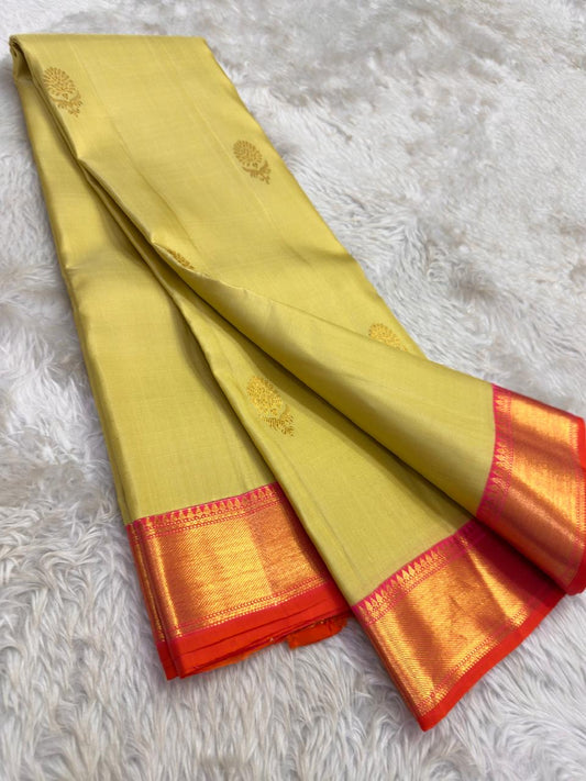 Beige Kanjivaram silk saree with coral contrast zari border and woven motifs