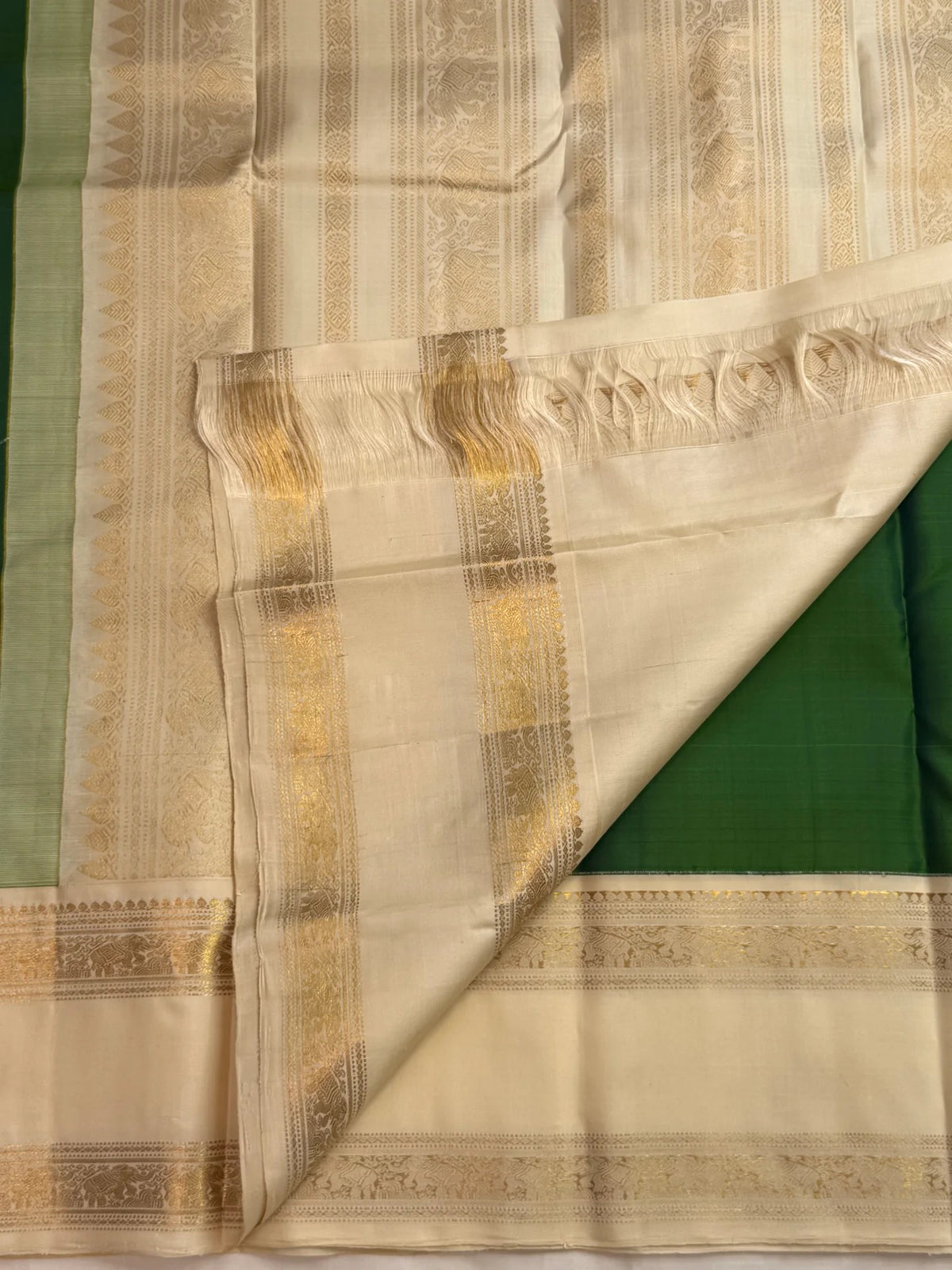 Double-shot leaf-to-emerald green with golden-mustard light pure silk Kanchipuram saree, vintage rettapet double border detail; traditional Rettapet weave.