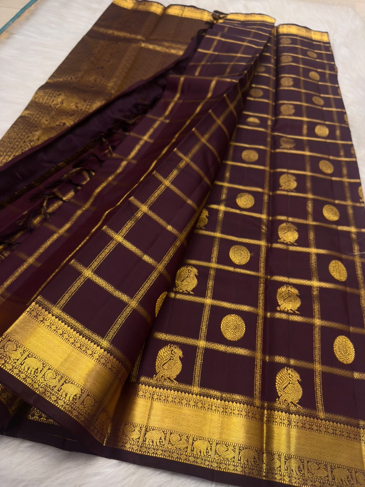 Traditional Zari Kattam Kanchipuram saree in deep aubergine with Mayil Chakram motifs, styled view