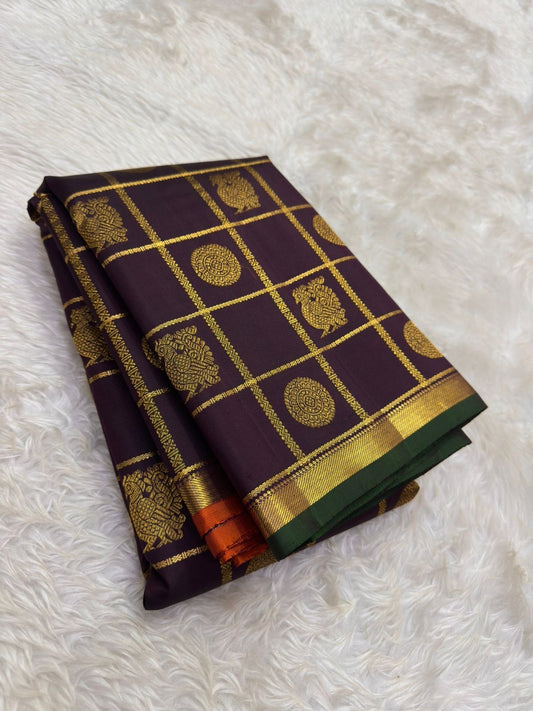 Deep plum Kanjivaram silk saree with traditional zari checks and woven motif detailing