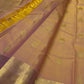 Sunset orange Kanchipuram silk saree, close-up of floral and teardrop gold zari buttas on rose-pink toned silk