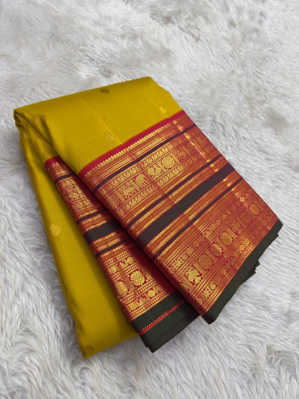 Turmeric Gold Kanjivaram silk saree with raspberry Korvai elephant zari border — Idam Living