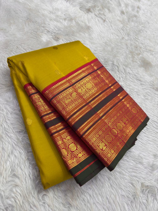 Turmeric Gold Kanjivaram silk saree with raspberry Korvai elephant zari border — Idam Living