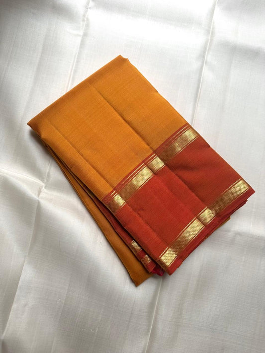 Rust Rettapet border with antique gold zari bands on turmeric gold Kanchipuram silk saree