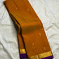Close view of antique-gold zari motifs woven on Ponvandu Turmeric Yellow Kanjivaram silk.