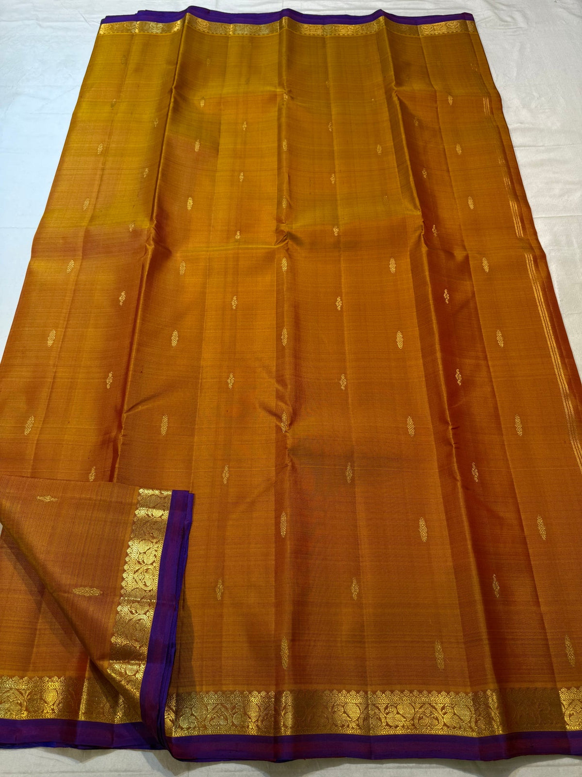 Ponvandu Turmeric Yellow Kanchipuram silk saree with individually spaced gold zari buttas.