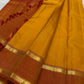 Turmeric-orange Manjal body against Arakku red border, Kanjeevaram saree close-up