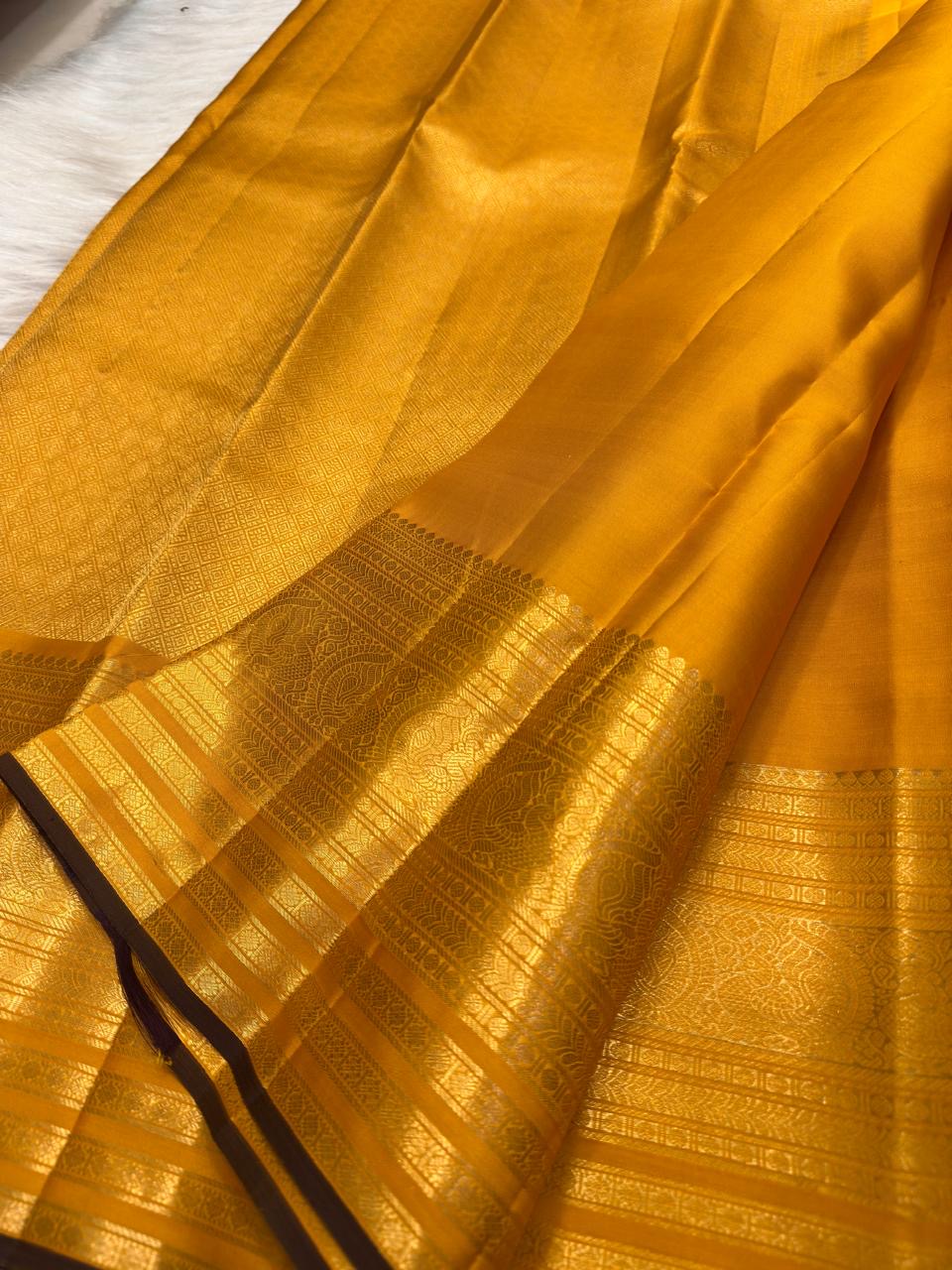 Turmeric Yellow handwoven pure silk Kanjivaram Butta saree with fine antique-gold zari buttas.