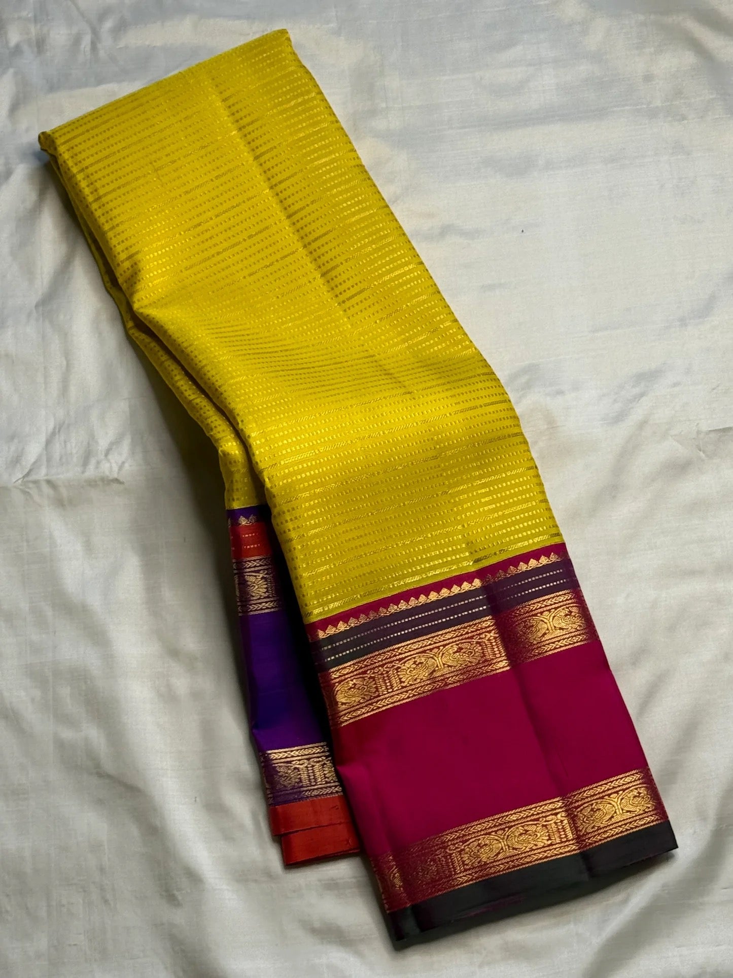 Turmeric Yellow pure silk Kanjivaram Rettapet saree with Ganga Jamuna Royal Purple and Rani Pink borders.