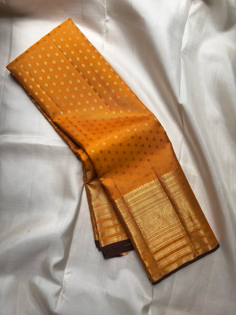 Broad traditional antique-gold border on Turmeric Yellow Kanjivaram saree.