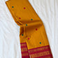 Turmeric yellow handwoven Kanchipuram Korvai saree with Kumkum red border