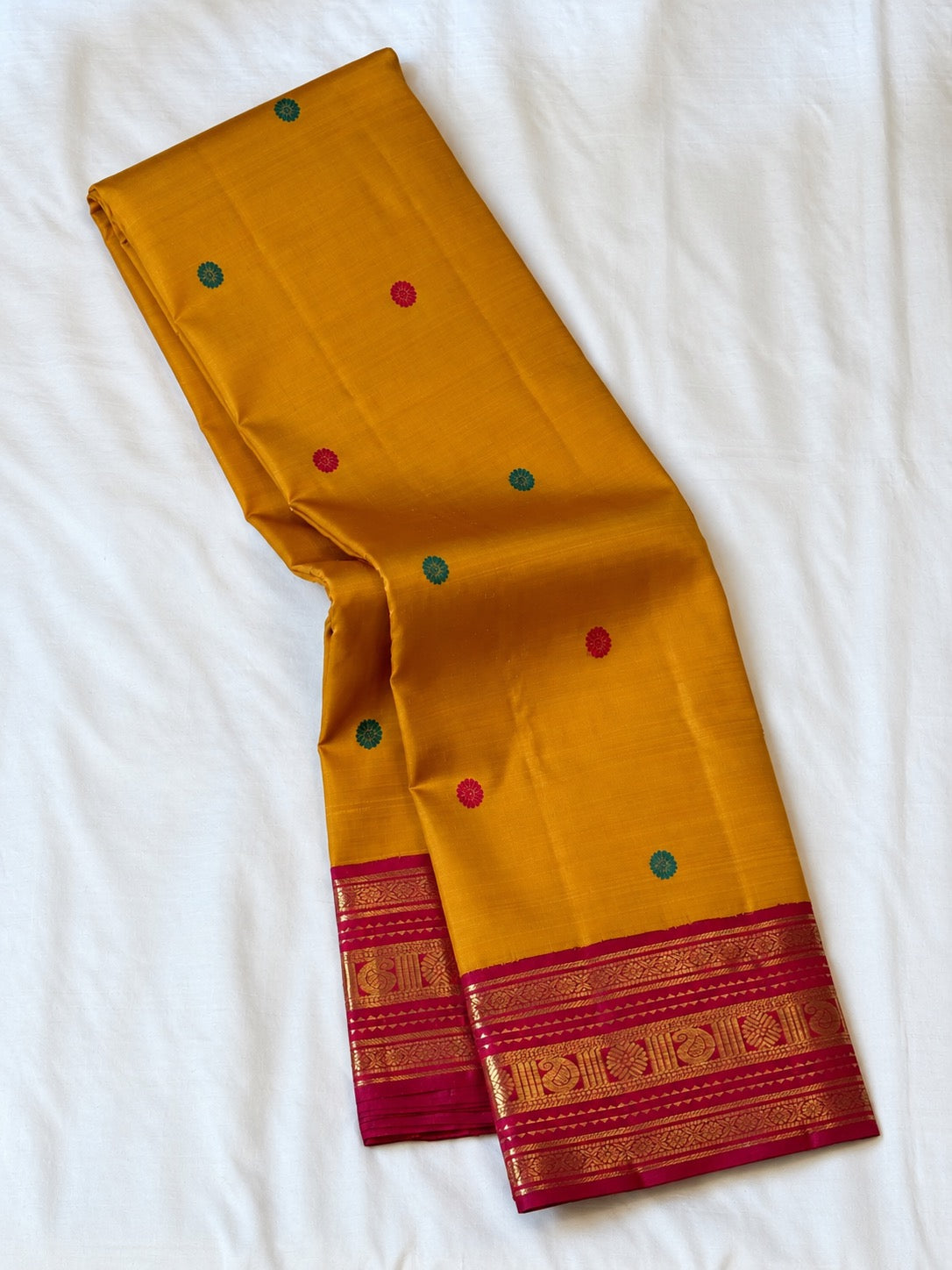 Turmeric yellow handwoven Kanchipuram Korvai saree with Kumkum red border