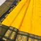 Turmeric Yellow pure silk KanchiPattu Butta saree with deep green double-peacock zari border.