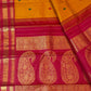 Turmeric yellow Kancheepuram Korvai saree with Kumkum red zari