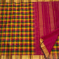 Turmeric yellow Kanchipattu saree with rani pink and emerald green checks detail