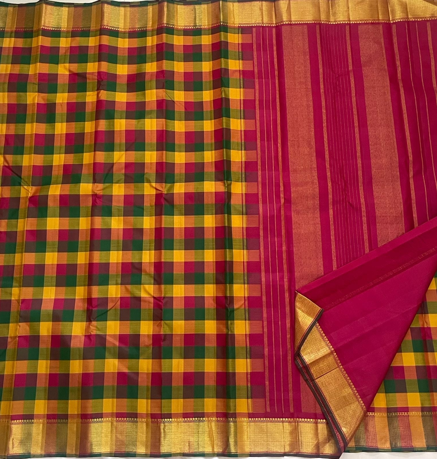 Turmeric yellow Kanchipattu saree with rani pink and emerald green checks detail