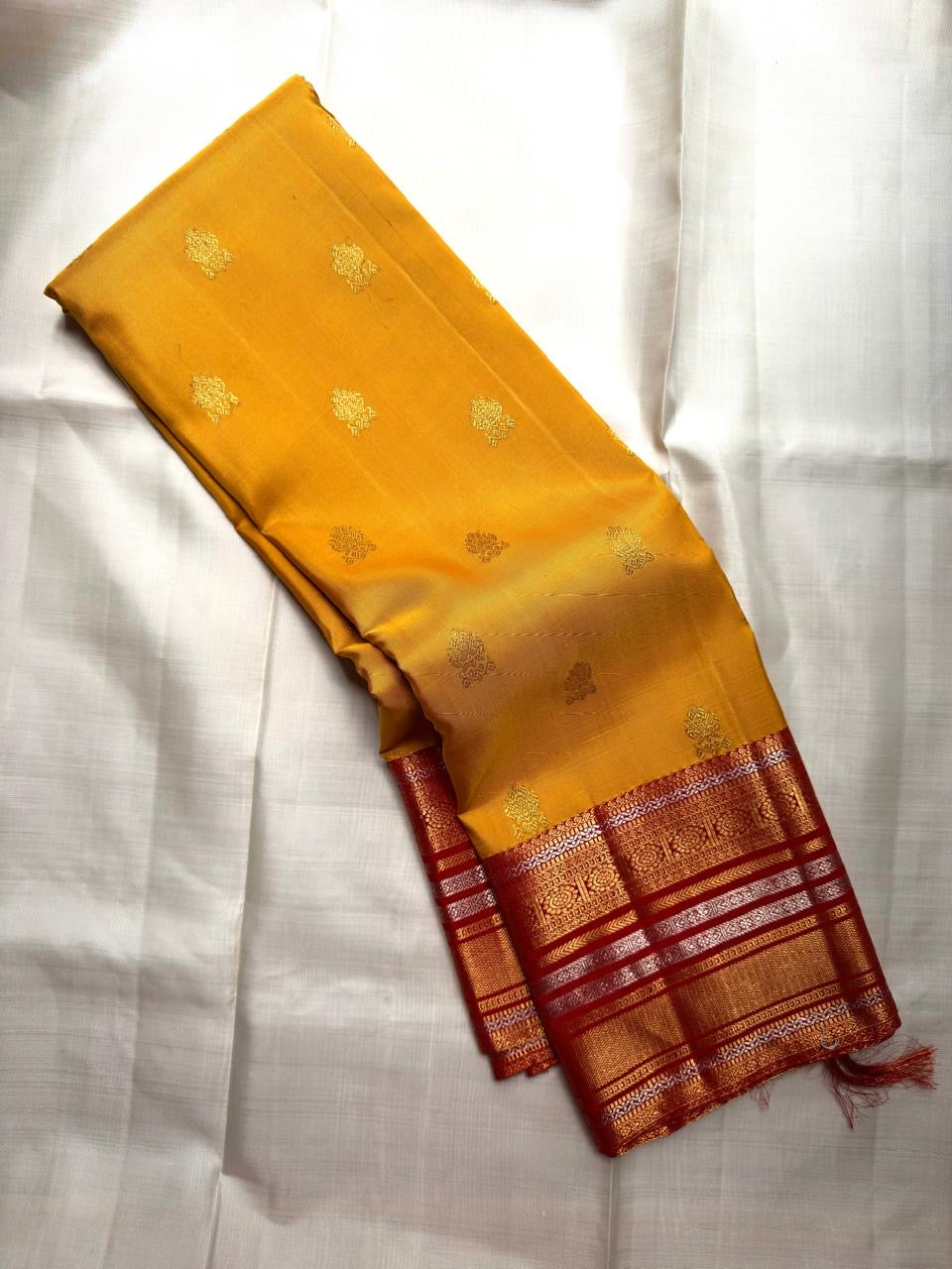 Turmeric Yellow Kanchipuram saree with Arakku Red Kanchi Pettu gold zari bands