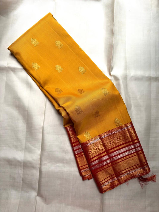 Turmeric Yellow Kanchipuram saree with Arakku Red Kanchi Pettu gold zari bands