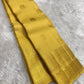 Turmeric yellow Pure Silk Kanchipuram saree with multi-layer Kamalam buttas and broad gold zari border.