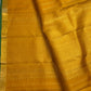 Turmeric yellow Kanchipuram silk saree with gold zari butta, draped view