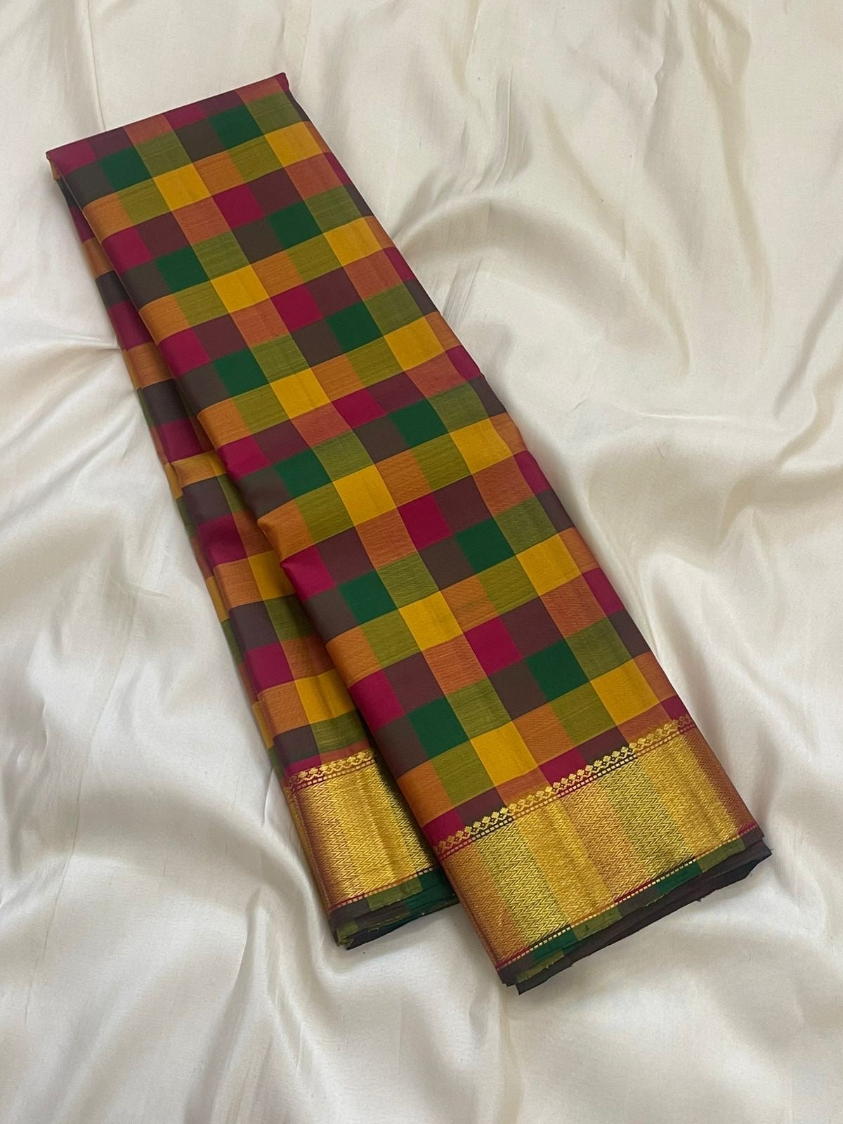 Turmeric yellow Kanchipuram silk saree with paalum pazhamum checks and antique gold zari border folded view